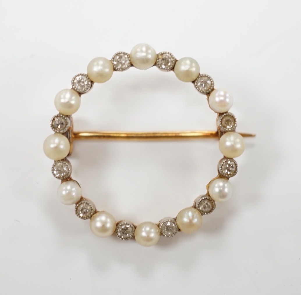 An Edwardian yellow metal, seed pearl and diamond chip set circular open work brooch, 22mm, gross weight 4 grams.
